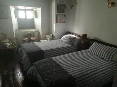 a living room with a black couch and a door at Las 3 Negrillas in Toral de Merayo