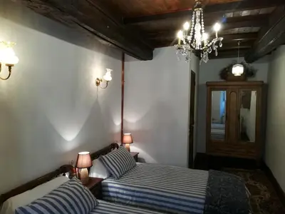 a bedroom with a bed and a dresser in a room at Las 3 Negrillas in Toral de Merayo