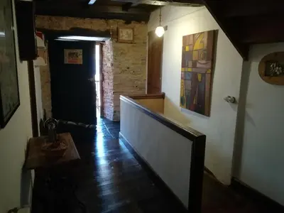 a bedroom with two beds and a chandelier at Las 3 Negrillas in Toral de Merayo