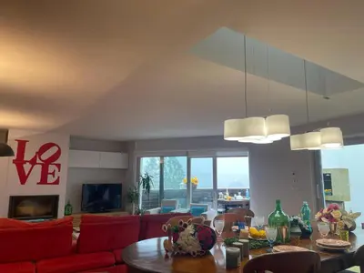 a living room with a red couch and a table at Gloria's Design House in Santiago de Compostela