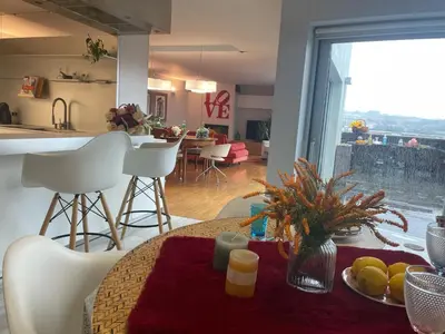 a kitchen and living room with a table with fruit on it at Gloria's Design House in Santiago de Compostela