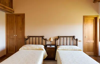 two beds sitting next to each other in a bedroom at Casa Lourán in Monfero
