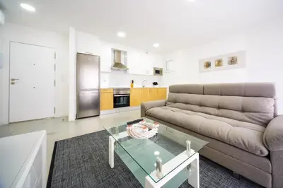 a living room with a couch and a glass table at Rueiro 17 in A Coruña