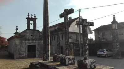 an old church with crosses and a car parked in front at Casa Cruceiro in Barcela