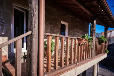 a wooden railing on a porch of a house at Casa Cruceiro in Barcela
