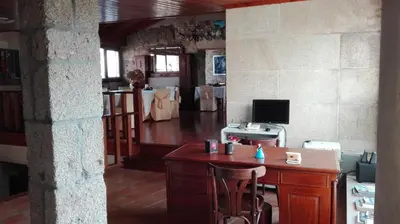a room with a desk and a computer on a table at Casa Cruceiro in Barcela