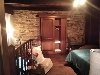 a room with a staircase with a door and a bed at Apartamento La Corrada in Santa Eulalia de Oscos