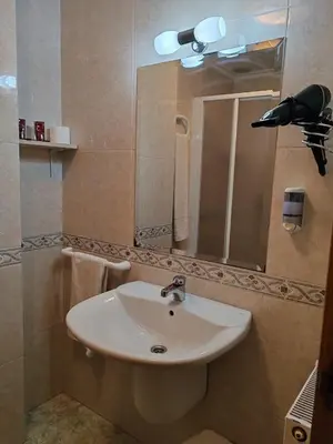 a bathroom with a white sink and a mirror at Hostal Ponte Dos Santos in Ribadeo