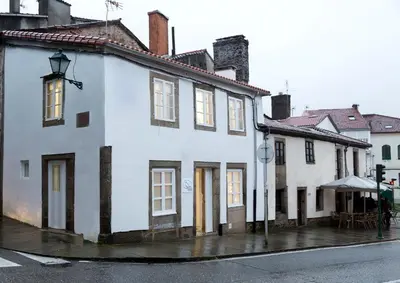 a white building on the side of a street at Apartamentos Pombal in Santiago de Compostela