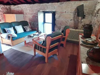 a living room with a couch and chairs and a table at Caserio de Fontes in Nogueira de Ramuin