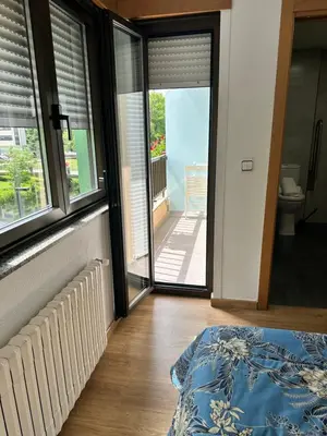 a bedroom with a door open to a balcony at El Malecon in Sarria