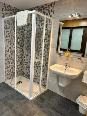 a bathroom with a shower and a sink at El Malecon in Sarria