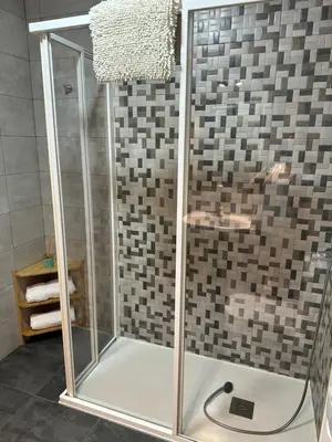 a shower with a glass enclosure in a bathroom at El Malecon in Sarria