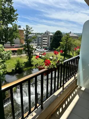 a balcony with a view of a river at El Malecon in Sarria