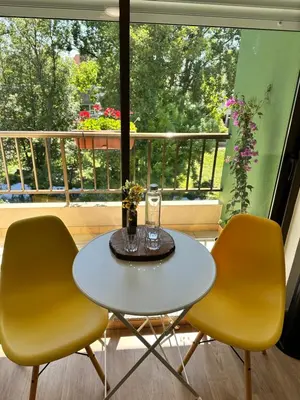 a table and two chairs in front of a window at El Malecon in Sarria