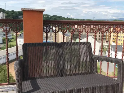 a metal bench sitting on top of a balcony at High Rentxacobeo in Sarria