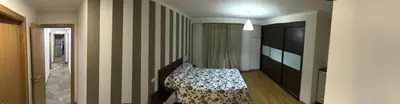a bedroom with a bed and a striped wall at High Rentxacobeo in Sarria
