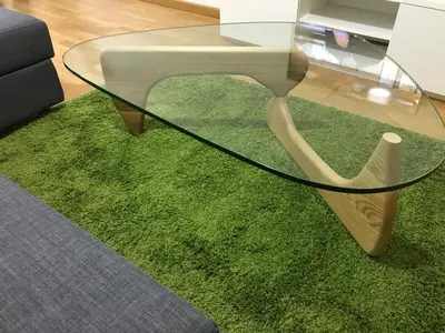 a glass coffee table sitting on a green rug at High Rentxacobeo in Sarria