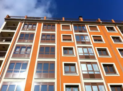 a tall orange building with windows on the side at High Rentxacobeo in Sarria