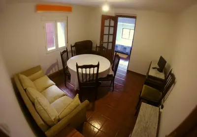 a living room with a couch and a table at Alojamientos turísticos VUT-LE-043 in Villablino