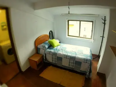 a small bedroom with a bed and a window at Alojamientos turísticos VUT-LE-043 in Villablino