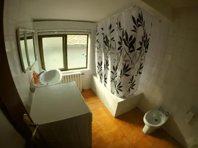 a small bathroom with a sink and a toilet at Alojamientos turísticos VUT-LE-043 in Villablino