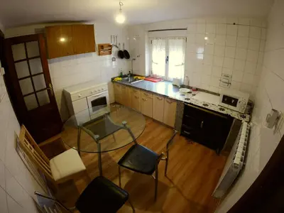 an overhead view of a kitchen with a table and chairs at Alojamientos turísticos VUT-LE-043 in Villablino