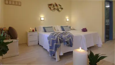 a bedroom with a bed with two lit candles and a table at Casa Do Medio in Santiago de Compostela