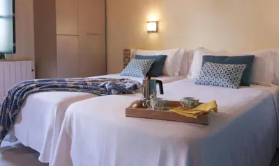 two white beds with a tray on top of them at Casa Do Medio in Santiago de Compostela
