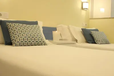 a room with a bed with pillows on it at Casa Do Medio in Santiago de Compostela