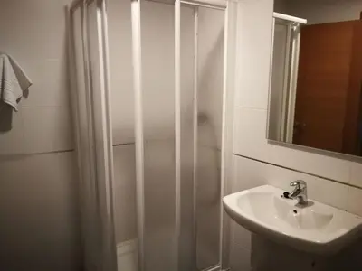 a bathroom with a shower and a sink at Pension Restaurante La Bombilla in A Estrada