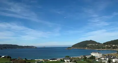 a view of a large body of water with houses at Hotel Ego in Viveiro