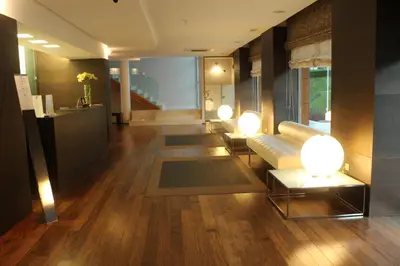 a living room with a couch and two tables at Hotel Ego in Viveiro
