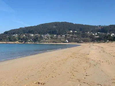 a beach with footprints in the sand at Hotel Ego in Viveiro