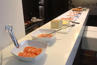 a buffet with bowls of food on a counter at Hotel Ego in Viveiro
