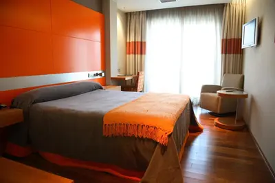 a hotel room with a bed and a window at Hotel Ego in Viveiro