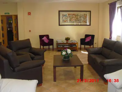 a living room with couches and chairs and a table at Hotel O Desvio in Santiago de Compostela