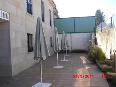 a row of umbrellas sitting next to a building at Hotel O Desvio in Santiago de Compostela