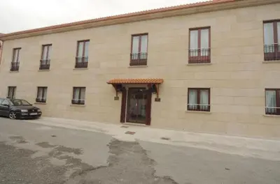 a building with a car parked in front of it at Hotel O Desvio in Santiago de Compostela