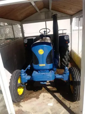 a blue tractor parked in a garage at Casa Quiroga in Lamas