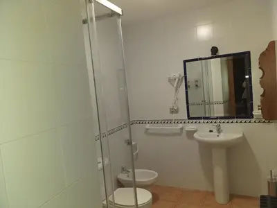 a bathroom with a shower and a toilet and a sink at Casa Quiroga in Lamas