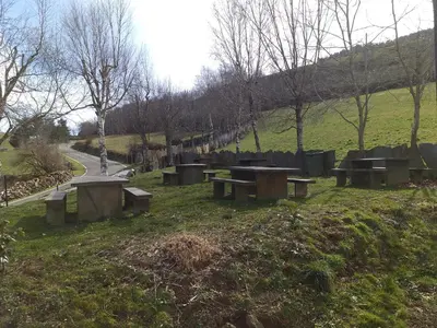 a group of benches in a park with a road at Casa Quiroga in Lamas