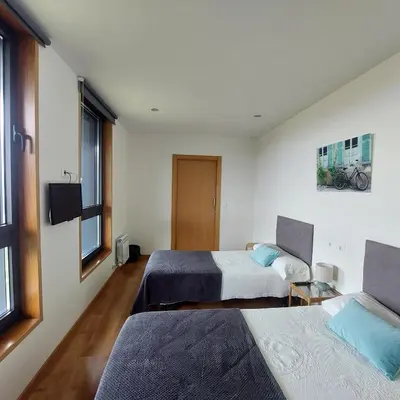 a room with three bunk beds and two windows at Linar Do Rei in Linares