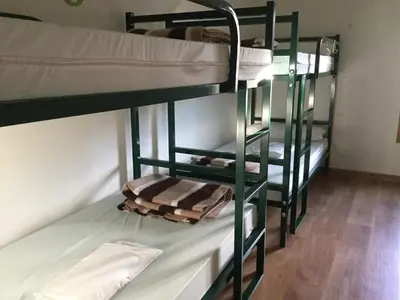 two bunk beds in a room with a hallway at Linar Do Rei in Linares