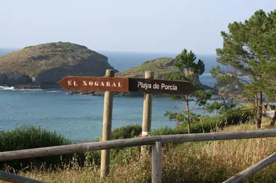 a street sign in front of the ocean at Casa Tésera in El Franco