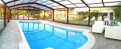 a swimming pool in a pavilion with a swimming pool at Casa Rural Elias in Molinaseca