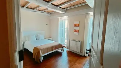 a bedroom with a bed and a large window at Hostal Camponaraya in Camponaraya