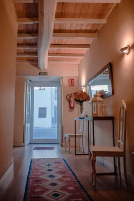 a hallway with a table and a chair and a door at Hostal Camponaraya in Camponaraya