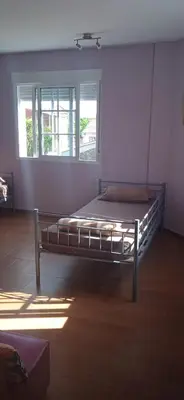 a large bed in a room with a window at Albergue o Apalpador in Melide
