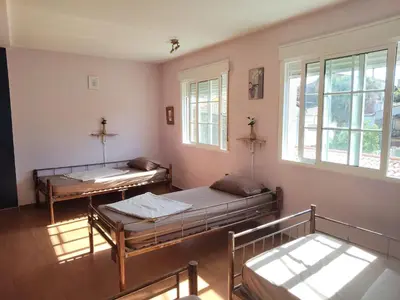 a room with two beds and a window at Albergue o Apalpador in Melide